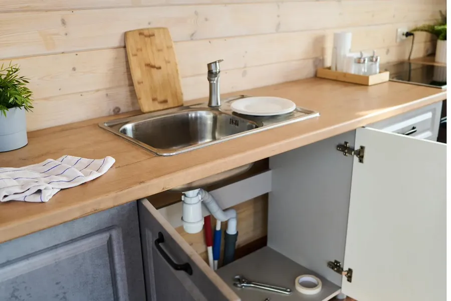 services-card-sinks A kitchen sink with the cabinet underneath open