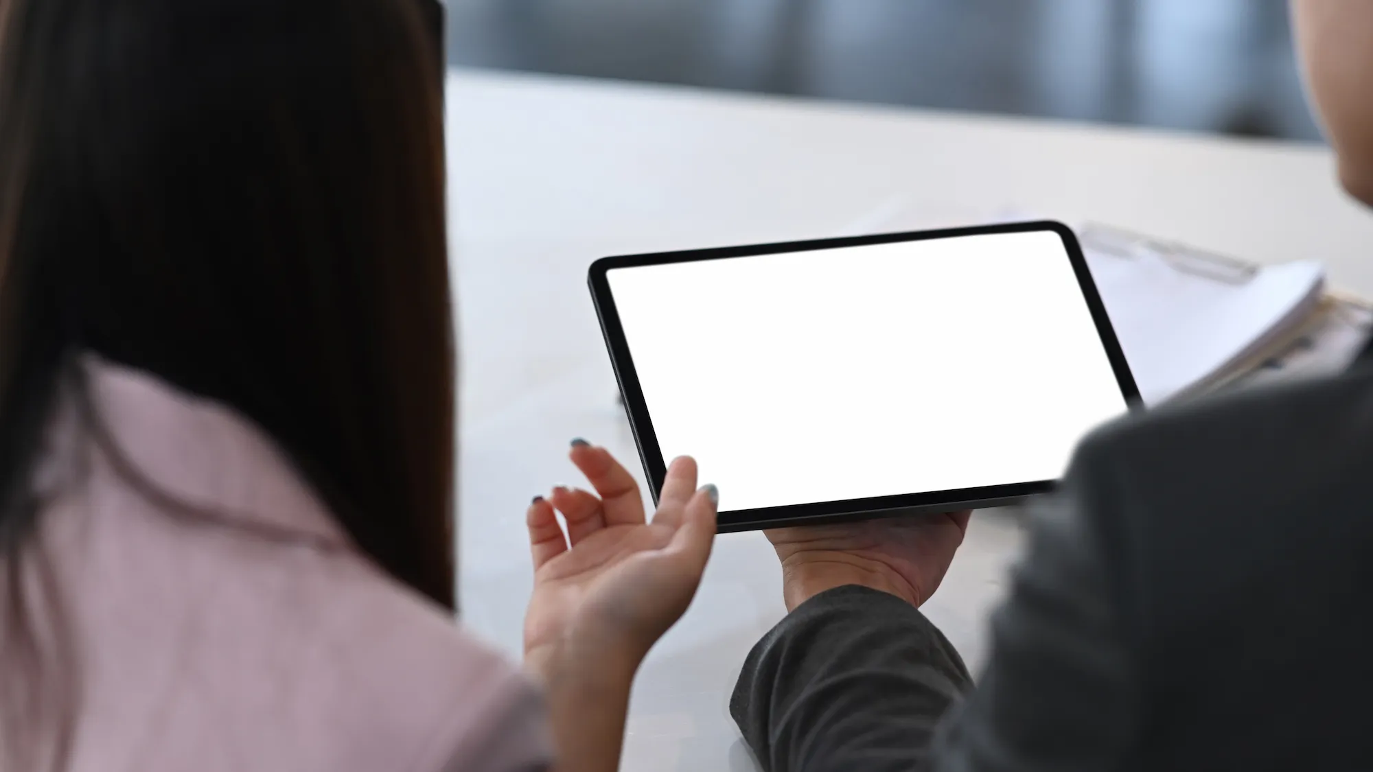 team-reviewing-tablet Two colleagues reviewing information on a tablet
